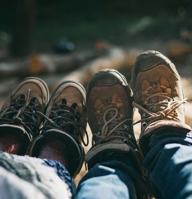 Two pairs of feet in hiking boots