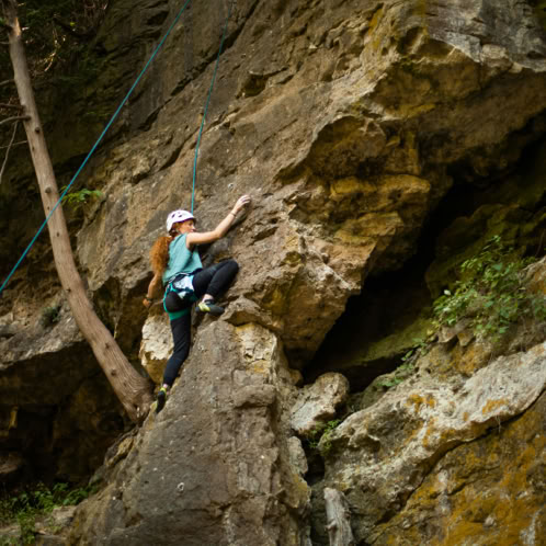 A woman rock climbing in the Irvine River Gorge, Elora ON Canada